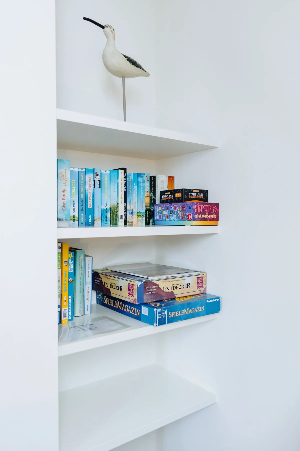 Ferienwohnung Wellenbrecher Sylt – Bücherregal mit Vogelfigur als Markenzeichen
